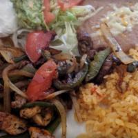 Lunch Fajitas Mixtas · Tender sliced steak and chicken cooked with bell peppers, onions and tomatoes.