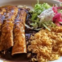 Mole Enchiladas · Three chicken enchiladas. Topped with our homemade mole sauce. Served with rice, lettuce, to...
