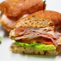 Smoked Turkey Sandwich · House smoked turkey breast with lettuce and tomato. Served on  focaccia bread, with a pickle...