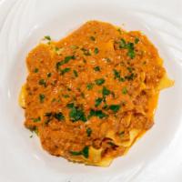 Pappardelle Bolognese · Fresh homemade wide fettuccine in a meat sauce.