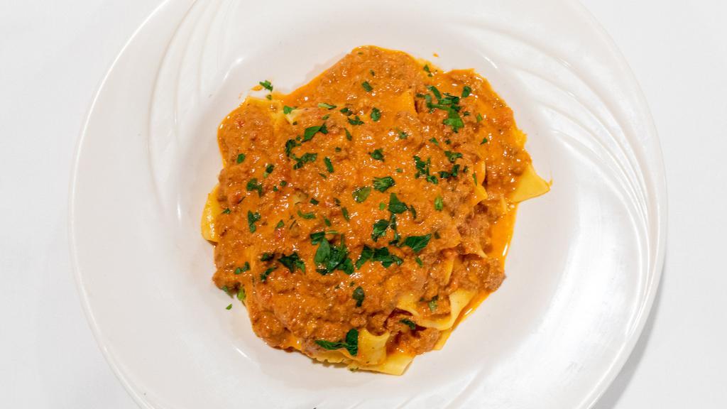 Pappardelle Bolognese · Fresh homemade wide fettuccine in a meat sauce.