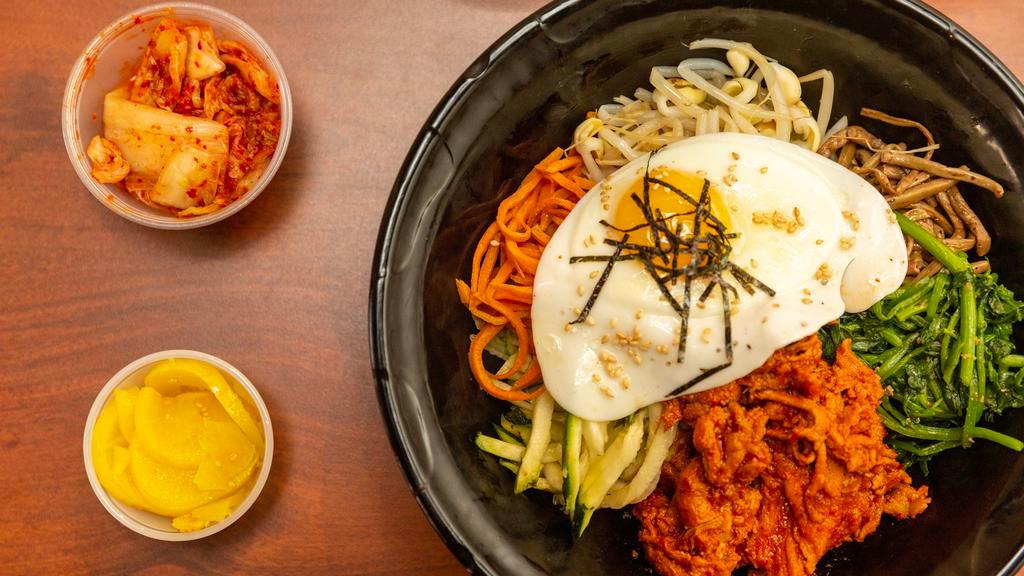 Spicy Pork Bibimbap · Medley of vegetables topped with fried egg and spicy pork.