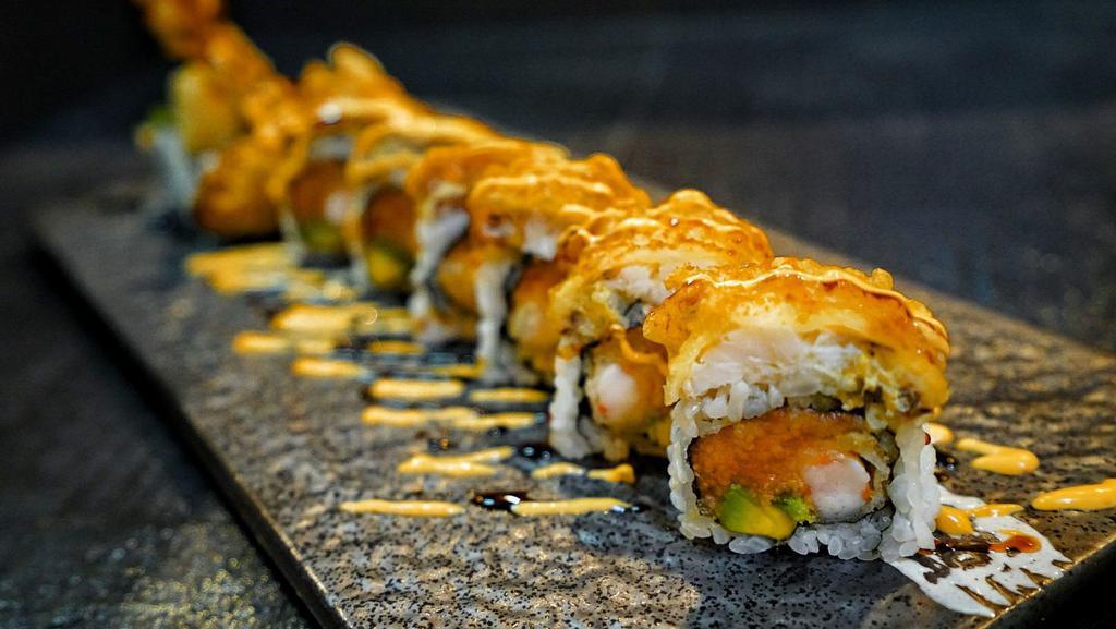 Dinosaur Roll · Shrimp tempura, spicy tuna and avocado, topped with soft shell crab served with spicy mayo sauce, eel sauce.