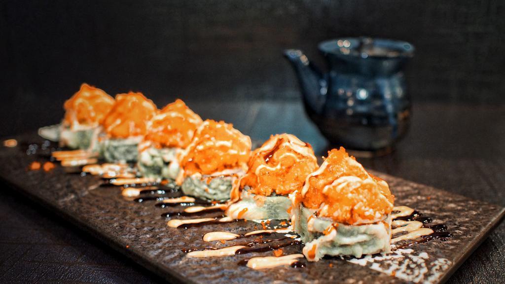 Volcano Roll · Kani and avocado in a roll,then deep fried. Topped with spicy tuna. Served with spicy mayo sauce and eel sauce.