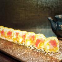Monster Roll · Tuna, salmon, yellowtail, tobiko and avocado wrapped in white seaweed paper.