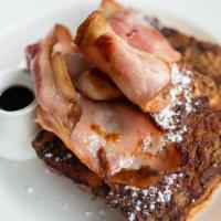 Ham French Toast With Syrup · Fresh fluffy French toast topped with slices of ham and syrup.