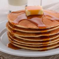 Pancake With Syrup · Three pieces of fluffy buttermilk pancakes with syrup.