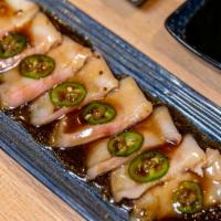 Yellowtail Carpaccio · Sliced yellowtail topped with jalapeno and onion with chef's special sauce.