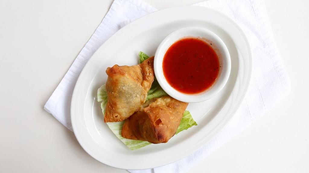 Vegetable Samosa (2 Pc) · Crisp triangle patties filled with m y spiced potato and green peas.