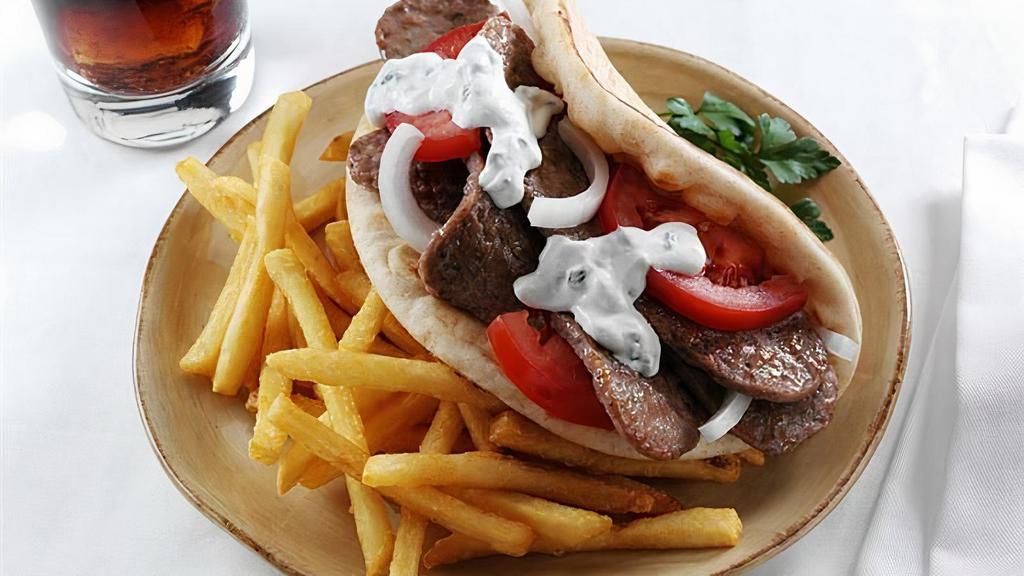 Lamb Gyro · Served on pita bread with lettuce, tomato, onions, and white sauce.