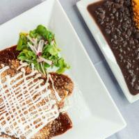 Enchiladas De Mole · Three chicken enchiladas topped with mole sauce, cheese, and sour cream. Served with rice an...