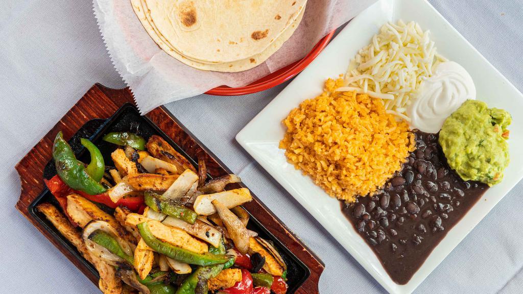 Chicken Breast Fajitas · Sautéed onions, red peppers, and green peppers served with grilled chicken, Mexican rice, beans, shredded cheese, sour cream, guacamole, and tortillas.