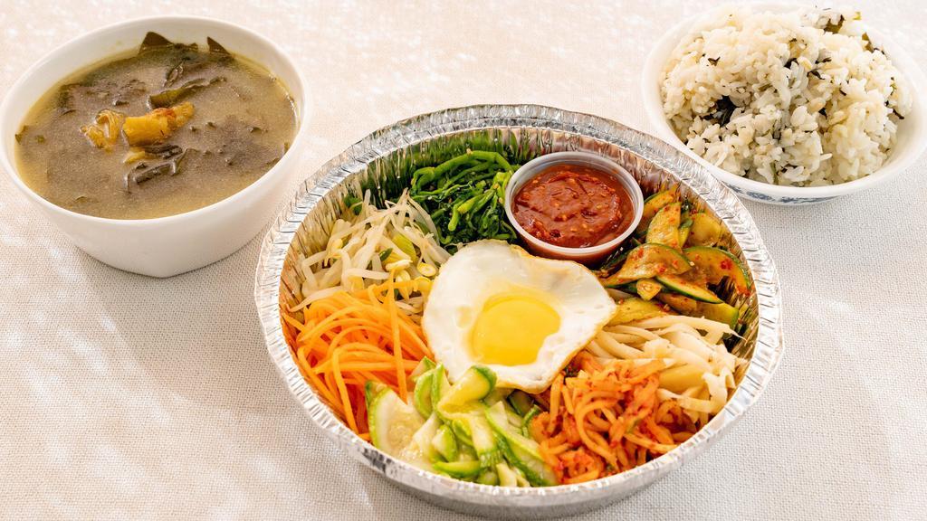 Bibimbap · assorted seasoned vegetables, a sunny-side up egg and red pepper paste sauce. Plus Korean side dishes and soup of the day