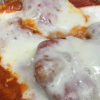 Chicken Parmigiana · Breaded and fried chicken breast topped with marinara and mozzarella, then baked.