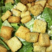 Caesar Salad · Hearts of romaine, homemade seasoned croutons and Caesar dressing. Sprinkled with grated Par...