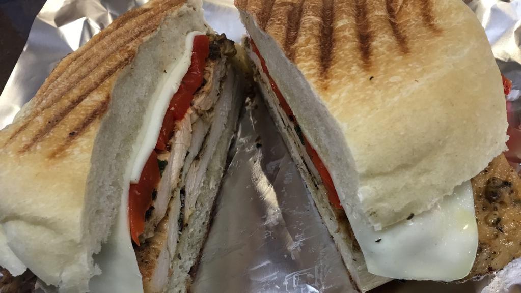 Chicken Panini · Grilled chicken with roasted red peppers, fresh mozzarella, salt, pepper and extra virgin olive oil.