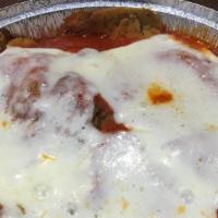 Eggplant Parmigiana · Breaded and fried eggplant topped with marinara sauce and mozzarella cheese, then baked.
