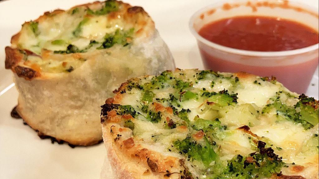 Broccoli Pinwheel · Homemade pizza dough and broccoli rolled up then sliced into thick pieces. Baked golden brown.