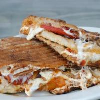 Breaded Chicken Panini · Thinly sliced chicken breast breaded with melted cheese on the top served in panini bread wi...