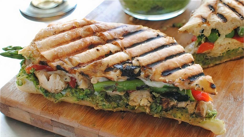 Chicken Pesto Panini · Grilled chicken, roasted peppers, pesto sauce, onion, tomato & melted swiss cheese.