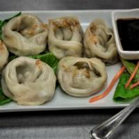 Steamed Vegetable Dumplings · Steamed soybean protein, onion, carrots, and cabbage. Served with a spicy soy sauce. 5 piece...