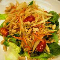 Som Tum · Papaya salad. Shredded green papaya, tomatoes and green beans tossed in a spicy lime juice d...