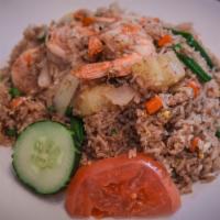 Pineapple Fried Rice · Fried rice with eggs, pineapple, onions, peas, carrots, and scallions.