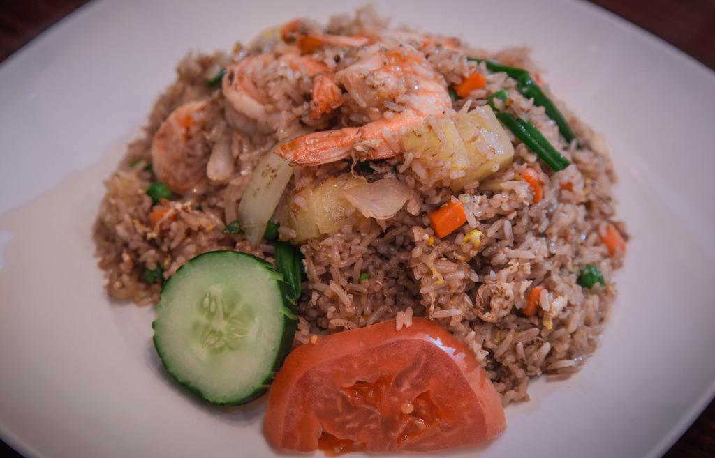 Pineapple Fried Rice · Fried rice with eggs, pineapple, onions, peas, carrots, and scallions.