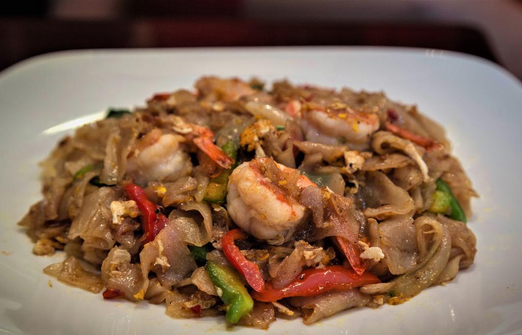 Pad Kee Moaw · Drunken noodles. Sauteed flat rice noodles with eggs, bell peppers, onions and thai basil. Spicy.