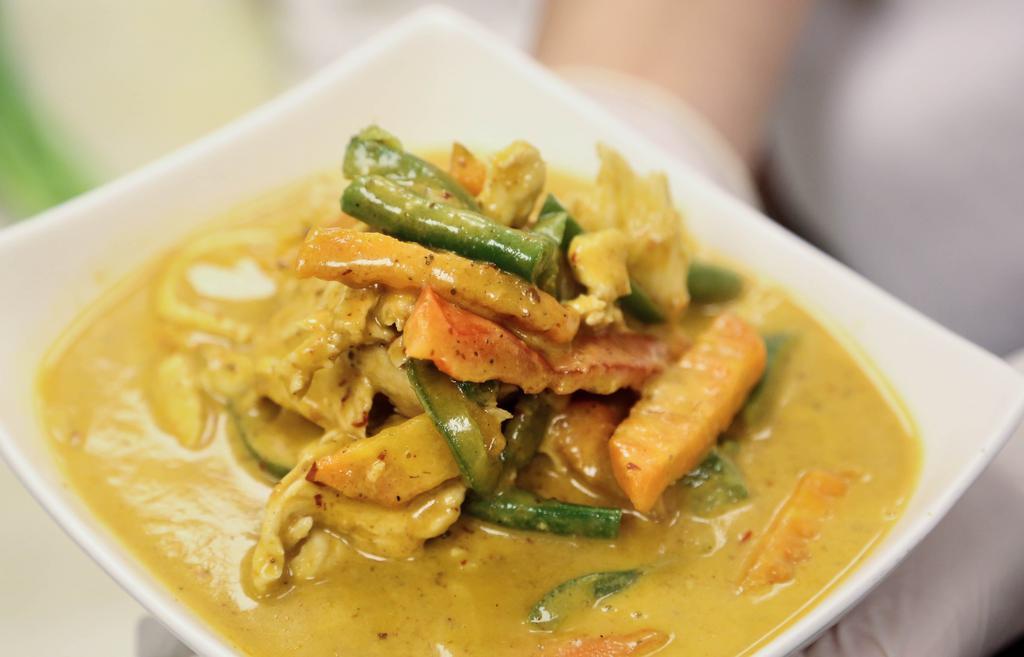 Panang Curry · Panang curry and coconut milk with bell peppers string beans and carrots. Spicy.
