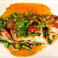 Pla Gra Pow · Deep fried choice of fish topped with sauteed bell peppers, mushrooms, and string beans in t...