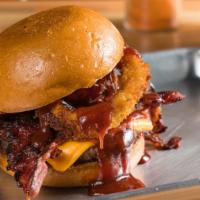 The Cowgirl · Our hand blended and pressed hamburger topped with American cheese, onion rings, bacon, and ...
