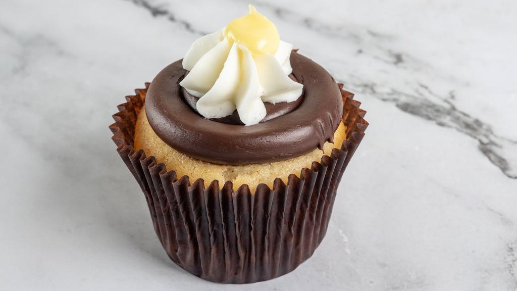 Boston Cream · Vanilla cake filled with Bavarian cream, frosted with fudge and topped with whipped cream and a dollop of Bavarian cream.