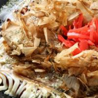 Okonomiyaki · Japanese style pancake w/veg, squid legs, pork and bonito flakes on top.