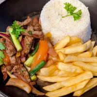 Lomo Saltado · beef fillet strips, stir-fried with soy sauce, spices, onions, tomatoes and fries. served wi...