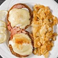 Eggs Benedict · Poached eggs with Canadian bacon on an English muffin topped with hollandaise sauce. Served ...