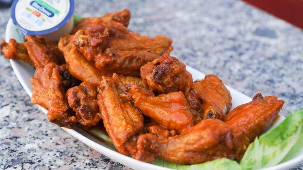 Chicken Wings · Delicious chicken wings smothered in buffalo sauce served with bleu cheese dressing for dipping. Choice of small ten pieces or large eighteen pieces.