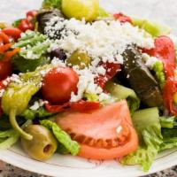 Greek Salad · Romaine lettuce, kalamata olives, cherry tomatoes, feta cheese, stuffed grape leaves, and ro...