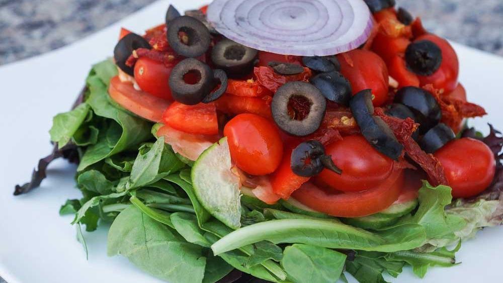House Salad · Mixed baby greens, sun-dried tomatoes, cucumbers, red and green peppers, tomatoes, olives, and Bermuda onions.