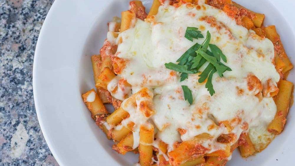 Baked Ziti · Al dente pasta smothered in our homemade marinara sauce and baked with ricotta and mozzarella cheeses.