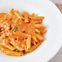 Penne Vodka · Served in a pink sauce with peas. Grilled chicken and grilled shrimp can be added for an ext...