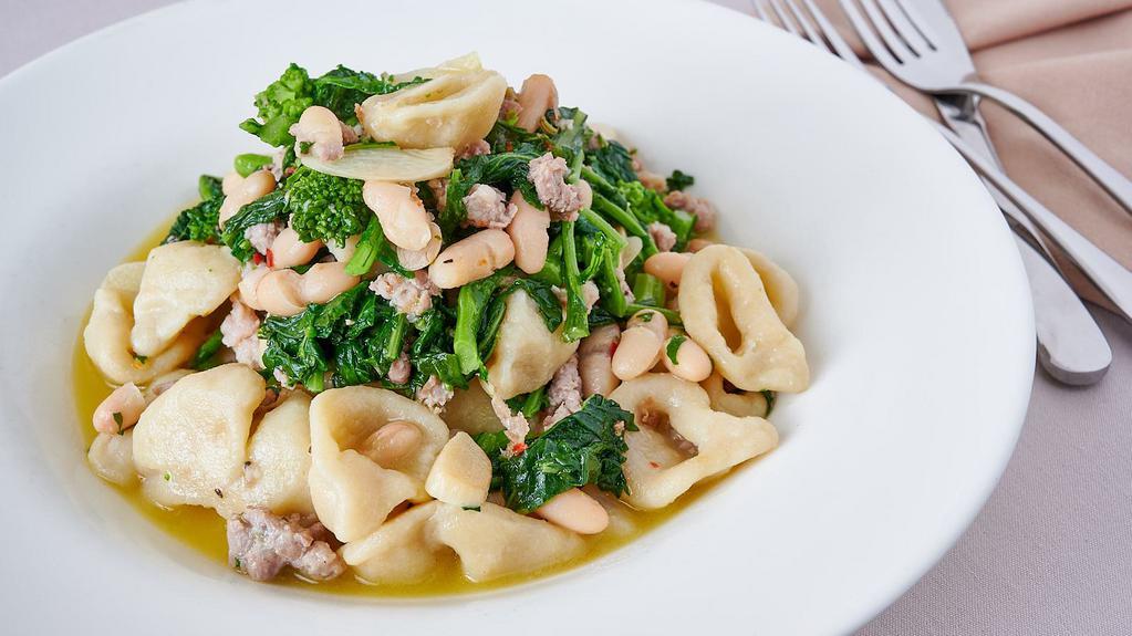 Orecchiette Barese · Ear shaped pasta served with crumbled sausage, broccoli rabe, pepper flakes and white cannellini beans in a white wine and garlic sauce.