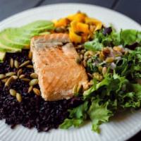 Wild Salmon Bowl · Forbidden black rice, mixed spring greens with mango and baked salmon. Topped with avocado, ...