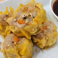 Steamed Dumpling · Ground chicken and shrimp, mushroom, carrot served with tangy soy sauce.