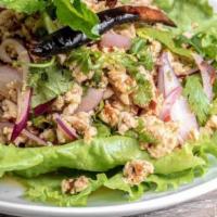 Larb Gai (Spicy Chicken Salad) · Gluten Free. Spicy**. Minced chicken, chili powder, roasted rice powder, red onion, mint, ci...