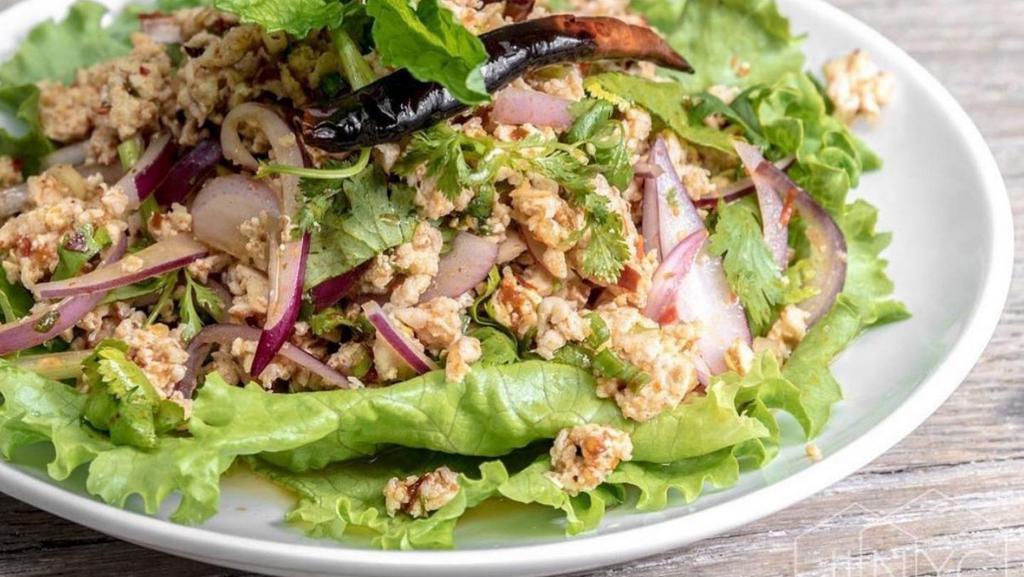 Larb Gai (Spicy Chicken Salad) · Gluten Free. Spicy**. Minced chicken, chili powder, roasted rice powder, red onion, mint, cilantro and scallions, with thai chili-lime dressing.