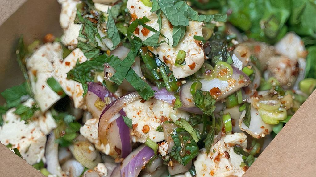  Larb Tofu (Spicy Tofu Salad) · Gluten Free, Spicy**, Steamed tofu,white mushroom, chili powder, roasted rice powder, red onion, mint, culantro, cilantro and scallions, with thai chili-lime dressing.