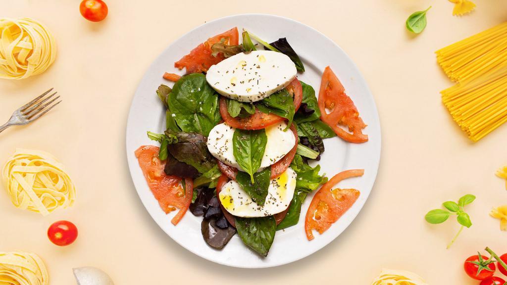 Caprese Salad  · Freshly sliced tomatoes served with basil, and mozzarella cheese.