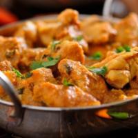 Chicken Kadhai · Chunks of chicken braised in a masala of coarse ground spices with sautéed onions and bell p...