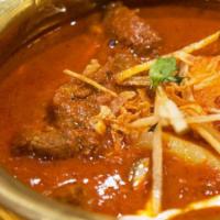 Lamb Vindaloo · Lamb cooked with potatoes in a tangy sauce.